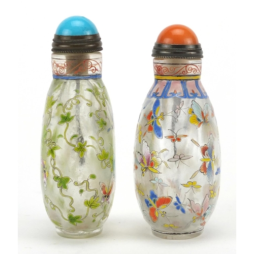 538 - Two Chinese glass snuff bottles with stoppers, each enamelled with butterflies, character marks to t... 