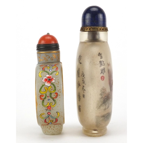 537 - Two Chinese glass snuff bottles with stoppers, one enamelled with butterflies amongst flowers, the o... 