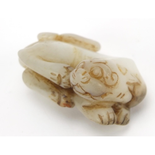 526 - Chinese white and russet jade carving of a lion, 7cm wide