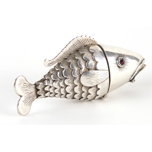 856 - Continental silver articulated fish pill box with hinged head, mouth and garnet eyes, indistinct sta... 