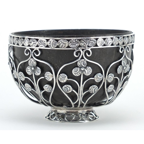 877 - Unmarked silver coconut footed bowl, set with miniature middle Eastern coins, 6cm high x 9cm in diam... 