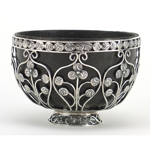 877 - Unmarked silver coconut footed bowl, set with miniature middle Eastern coins, 6cm high x 9cm in diam... 