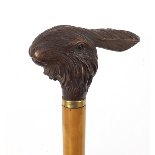 109 - Black Forest parasol with carved rabbit head handle and 18ct gold plated collar, 90.5cm in length