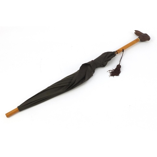 109 - Black Forest parasol with carved rabbit head handle and 18ct gold plated collar, 90.5cm in length