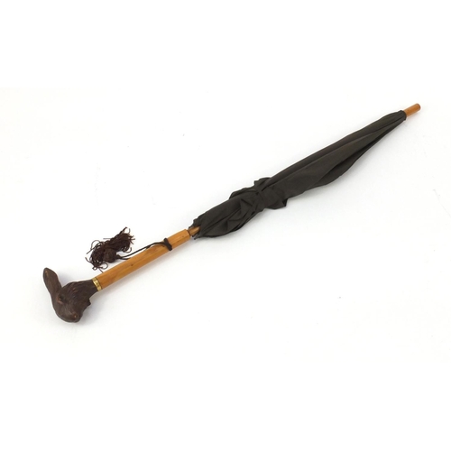 109 - Black Forest parasol with carved rabbit head handle and 18ct gold plated collar, 90.5cm in length