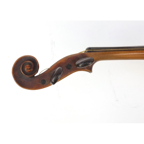 135 - Old wooden violin with one piece back, wax seal, bow and tooled leather case, the violin bearing an ... 