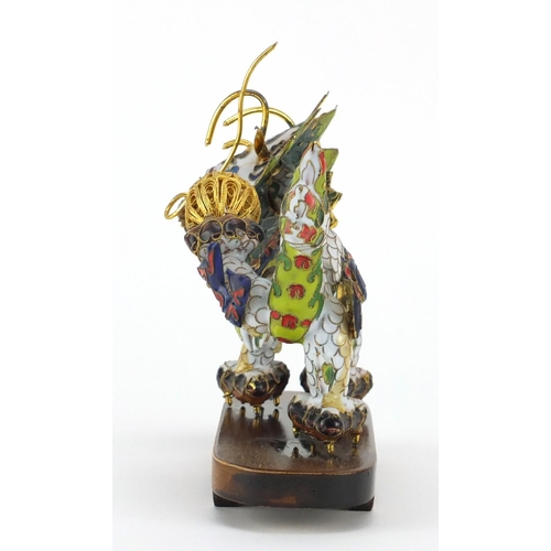 554 - Chinese gilt metal and enamel dragon raised on hardwood stand, 22.5cm in length