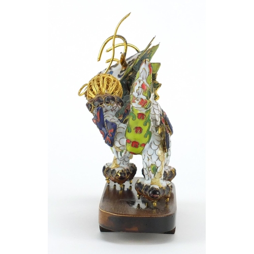 554 - Chinese gilt metal and enamel dragon raised on hardwood stand, 22.5cm in length