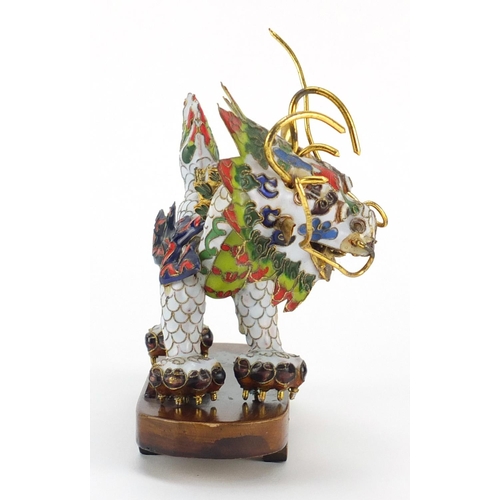 554 - Chinese gilt metal and enamel dragon raised on hardwood stand, 22.5cm in length