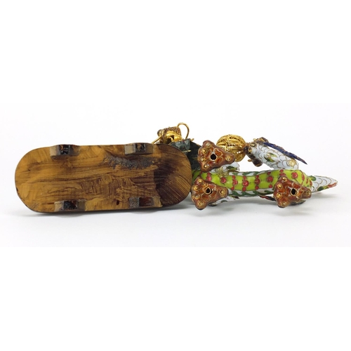 554 - Chinese gilt metal and enamel dragon raised on hardwood stand, 22.5cm in length