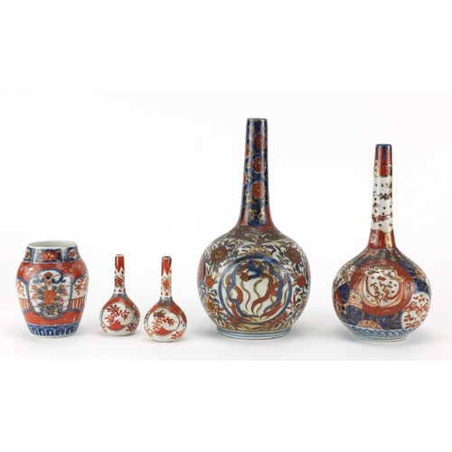 503 - Japanese Imari porcelain including two bottle vases hand painted with flowers, the largest 22cm high