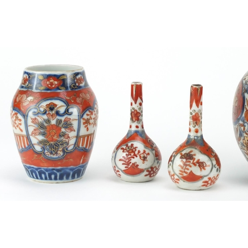 503 - Japanese Imari porcelain including two bottle vases hand painted with flowers, the largest 22cm high