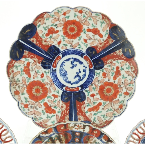504 - Japanese Imari porcelain including a charger and a pair of plates with pierced borders, hand painted... 