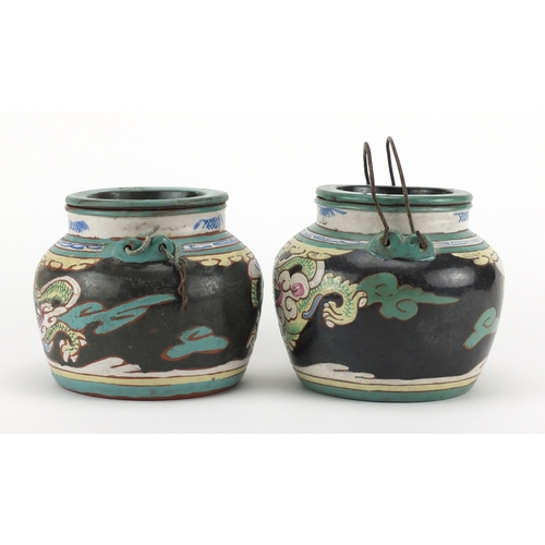 475 - Pair of Chinese yixing terracotta teapots, each enamelled with dragons chasing the flaming pearl, im... 