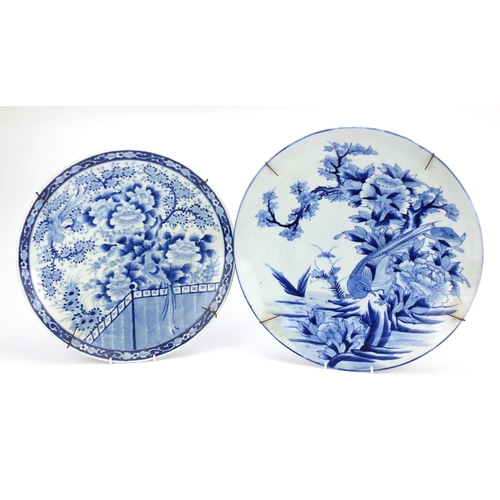 500 - Two Japanese blue and white porcelain chargers, both hand painted with of paradise amongst flowers, ... 