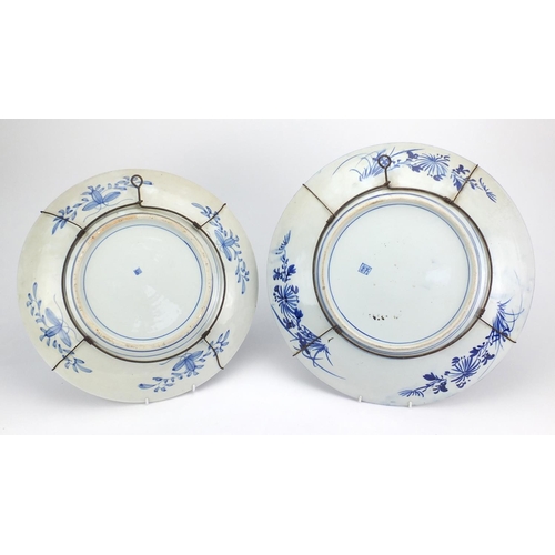 500 - Two Japanese blue and white porcelain chargers, both hand painted with of paradise amongst flowers, ... 