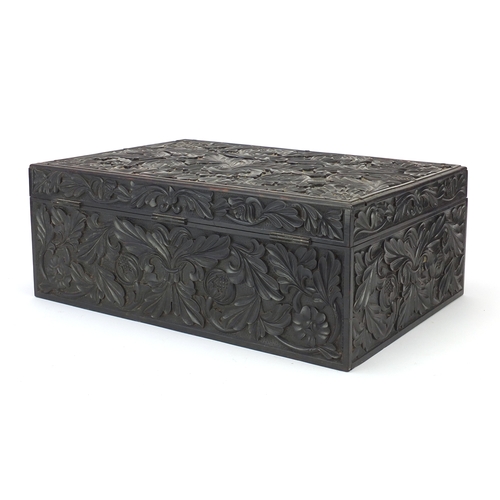 644 - **Withdrawn**Anglo-Indian ebony box profusely carved with flowers, the hinged lid opening to reveal ... 