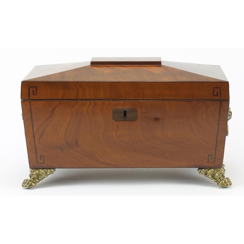 34 - Georgian inlaid mahogany sarcophagus shaped tea caddy, with ring turned lion head handles and paw fe... 