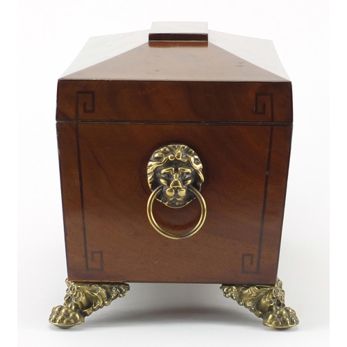 34 - Georgian inlaid mahogany sarcophagus shaped tea caddy, with ring turned lion head handles and paw fe... 