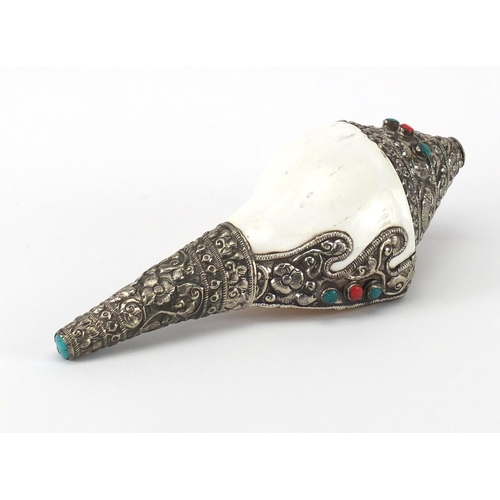 622 - Tibetan conch shell with silver coloured metal overlay, inset with coral and turquoise coloured ston... 