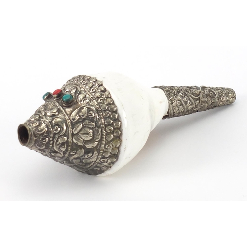 622 - Tibetan conch shell with silver coloured metal overlay, inset with coral and turquoise coloured ston... 