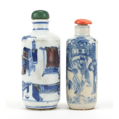 467 - Two Chinese porcelain snuff bottles and stoppers including a blue and iron red example, hand painted... 