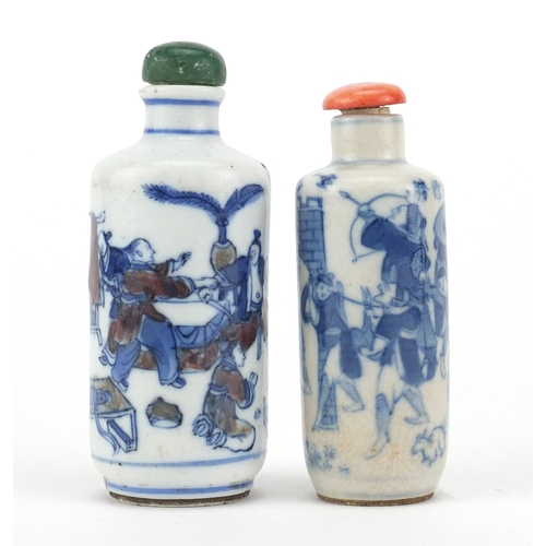 467 - Two Chinese porcelain snuff bottles and stoppers including a blue and iron red example, hand painted... 