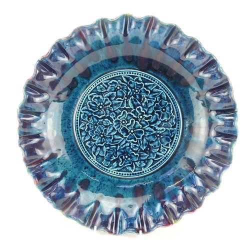 771 - Linthorpe pottery shallow dish with fluted rim, moulded in low relief with flower heads, impressed f... 