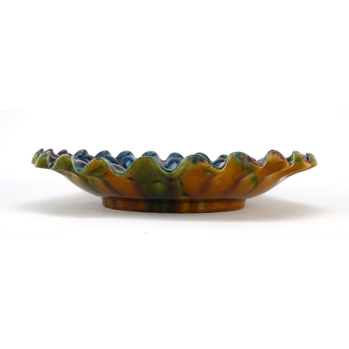 771 - Linthorpe pottery shallow dish with fluted rim, moulded in low relief with flower heads, impressed f... 