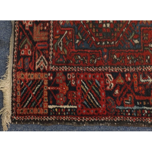 2127 - Rectangular Persian Heriz carpet runner, the central field having a stylised repeat flower head desi... 