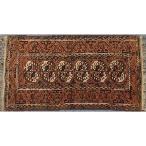 2117 - Rectangular Persian Baluch Bakahra design rug, the central field having a repeat flower head design,... 