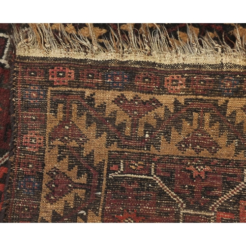 2137 - Rectangular Persian Baluch rug, the central field having an all over flower head design, 137cm x 89c... 