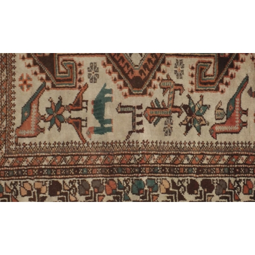 2125 - Rectangular South Persian rug, the central field having a camel and bird design within floral border... 