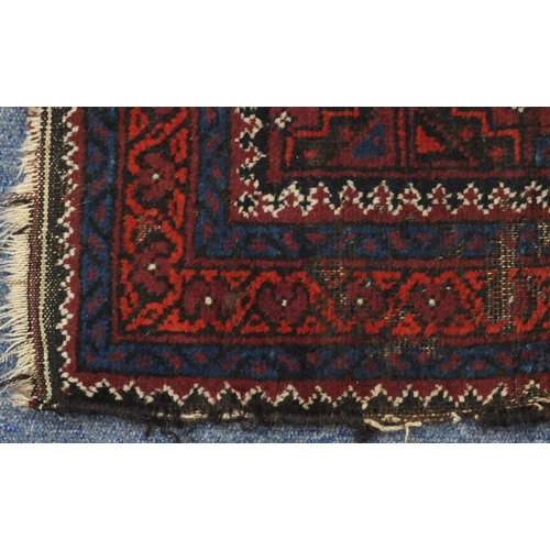 2148 - Rectangular Afghan Baluch rug having an all over stylised floral design within corresponding borders... 