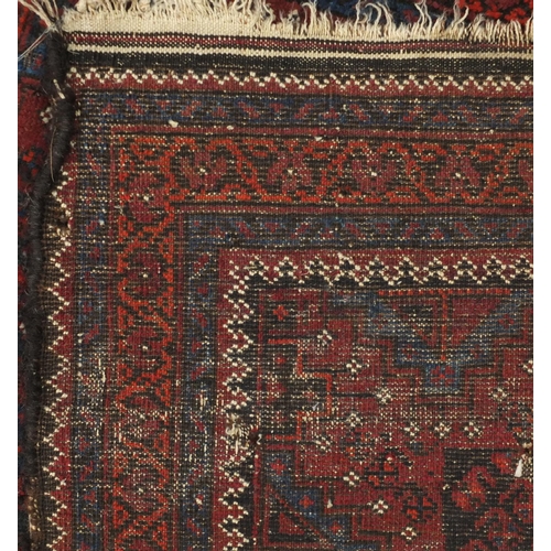 2148 - Rectangular Afghan Baluch rug having an all over stylised floral design within corresponding borders... 