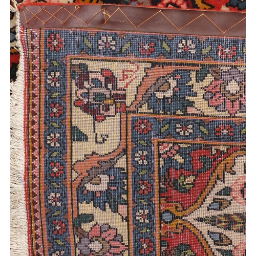 2084 - Rectangular Persian Bakhtiari rug, the central field having a garden design onto red ivory and midni... 