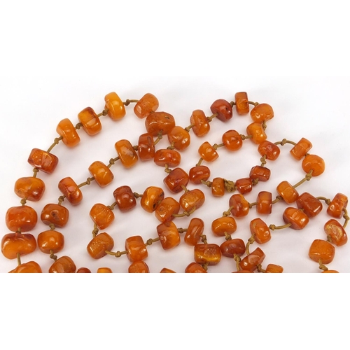 3062 - Amber coloured bead necklace, 124cm in length, approximate weight  72.2g