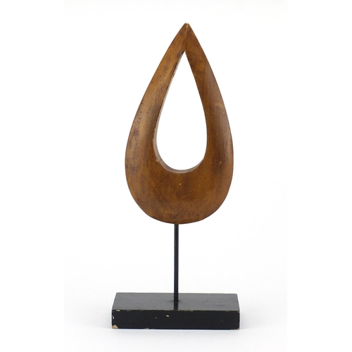 2193 - 1970's modernist carved wood sculpture, raised on a rectangular ebonised base, 33.8cm high
