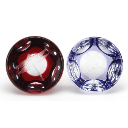 2196 - Two Bohemian flashed glass paperweights, etched with a dragonfly and butterfly, each 7.5cm in diamet... 