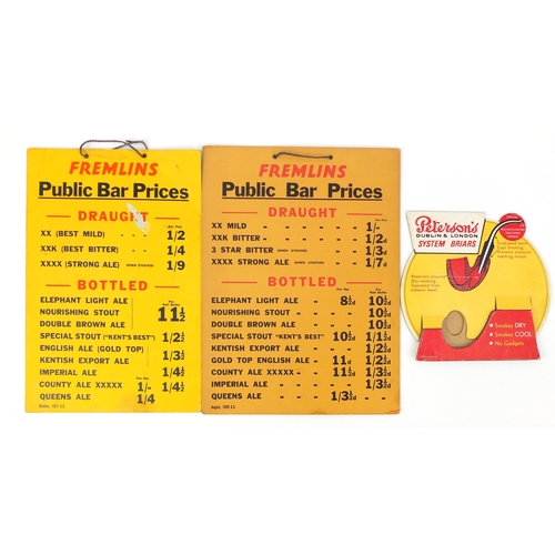133 - Two Fremlins public bar prices board signs and a Peterson's advertising pipe display stand, the larg... 