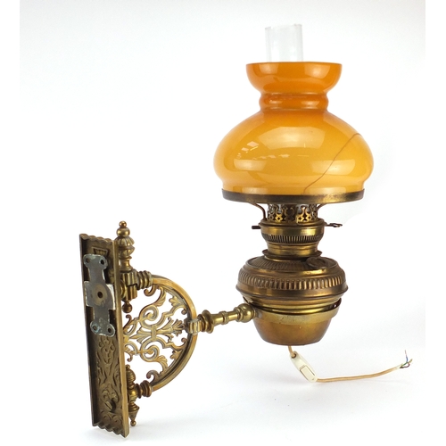 17 - Victorian ornate pierced brass wall bracket with Hinks patent oil lamp, with glass shade and funnel,... 