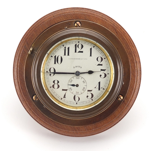 121 - Octo eight day car clock retailed by G Frodsham & Co, with Arabic numerals on circular wooden base, ... 