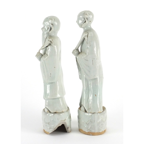 487a - Pair of Chinese celadon glazed pottery scholars, the largest 23cm high