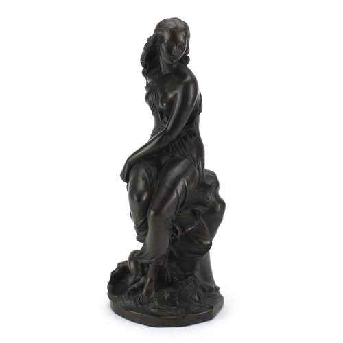 2410 - Bronzed figurine of a seated semi nude female, 39cm high
