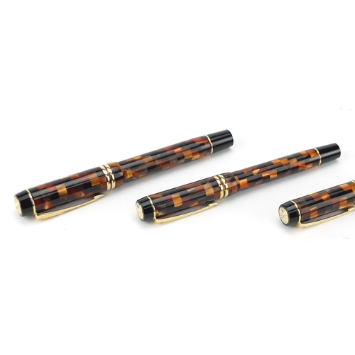 2713 - Unused Parker Duofold amber chequered three pen set, the smallest stamped sample, each with 18k gold... 