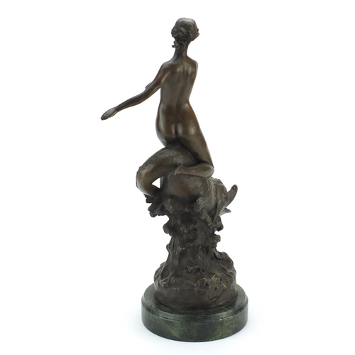 2178 - Large patinated bronze study of a nude Art Deco female upon a dolphin, raised on a circular green ma... 