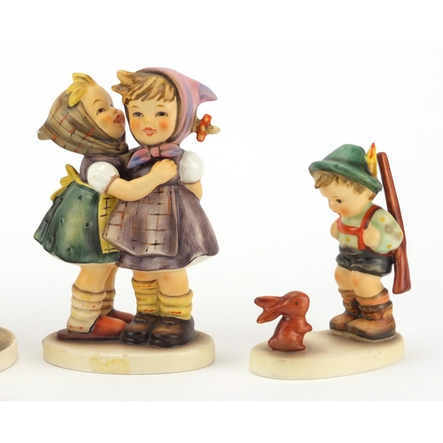 2389 - Four Goebel Hummel figures including Telling Her Secret and Farm Boy, the largest 13.5cm high