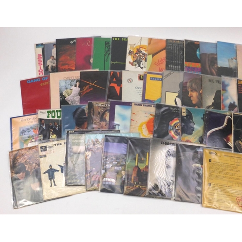 2671 - Predominantly Rock vinyl LP's and programmes  including Pink Floyd, David Bowie, Eagles, The Beatles... 