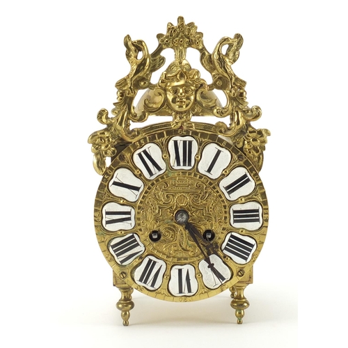 2295 - 17th style ornate brass lantern mantel clock striking on a bell, with enamelled Roman numerals, the ... 