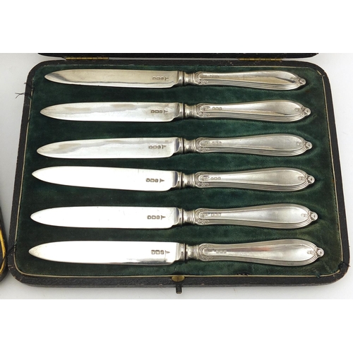 2876 - Set of six silver butter knives and apostle spoons including Walker & Hall, both with fitted cases, ... 
